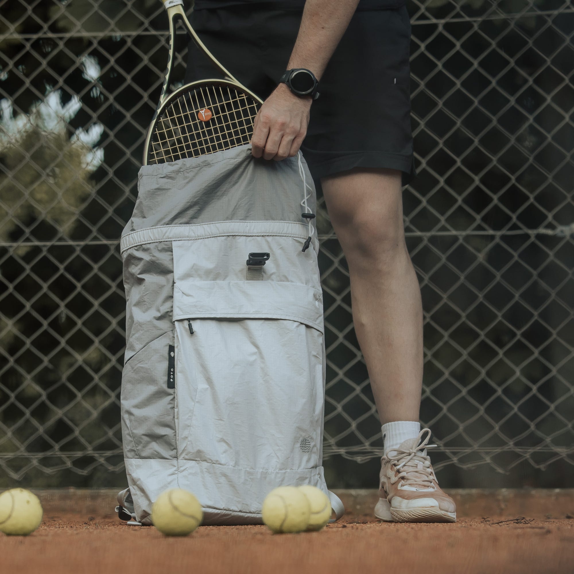 eoto Rucksack auf dem Tennisplatz